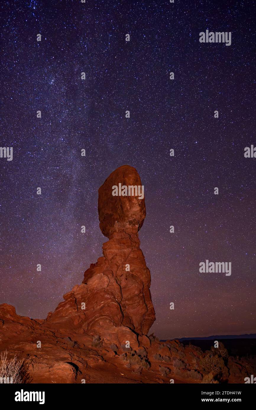 Northern end of the Milky Way over Balanced Rock in Arches National Park in winter in Utah. Stock Photo