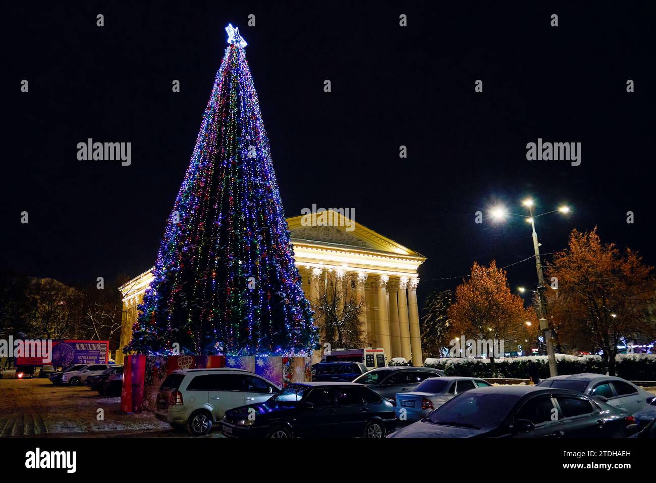 Ryazan, Russia - December 16, 2023: New Year tree on the city square with the theater building in the background Stock Photo