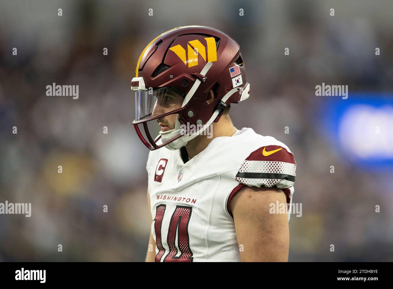 Washington Commanders quarterback Sam Howell (14) wears a helmet with a