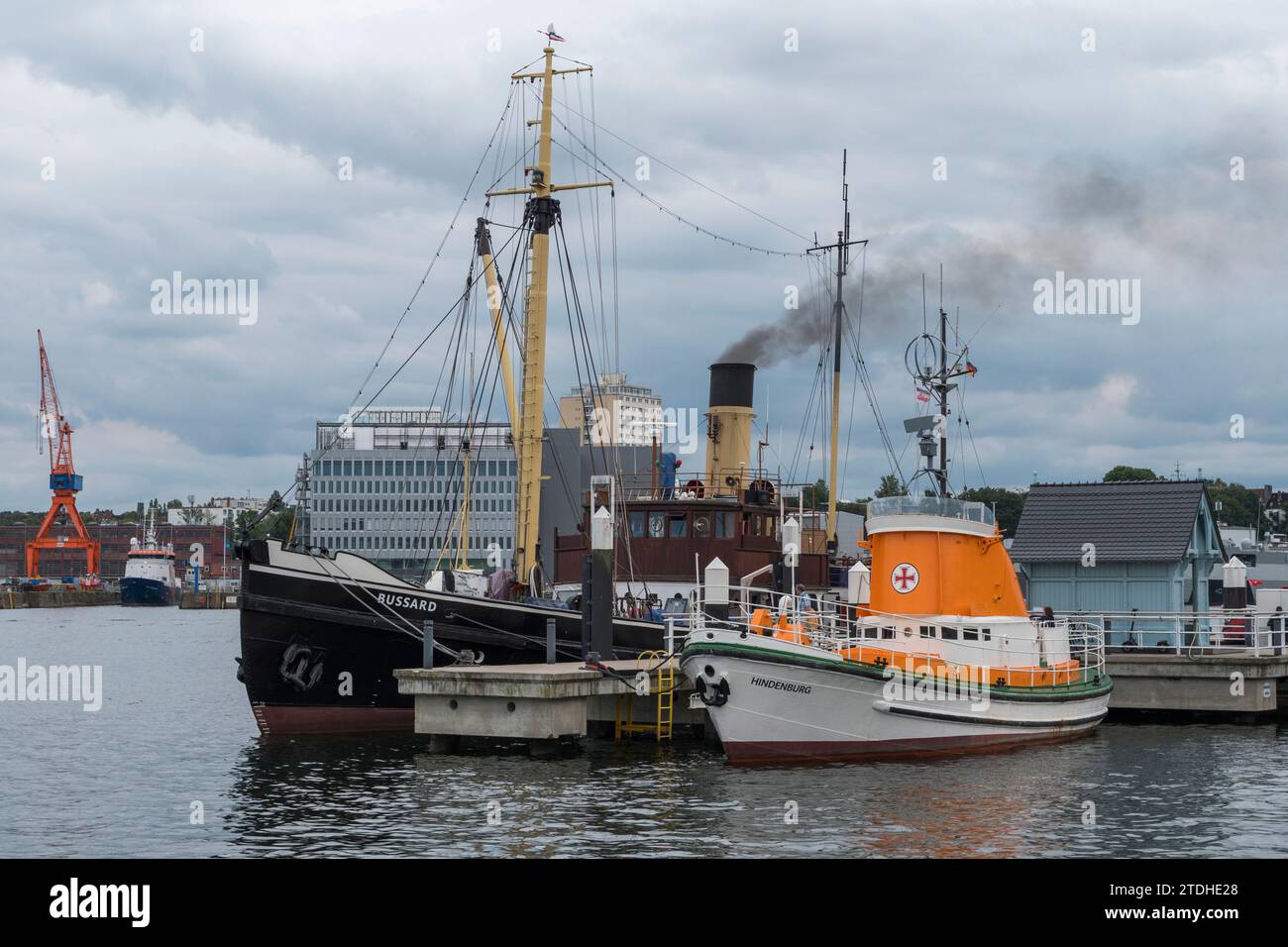 The 'Bussard' steamboat and German rescue boat 'Hindenburg' moored in Kiel, Germany. Stock Photo