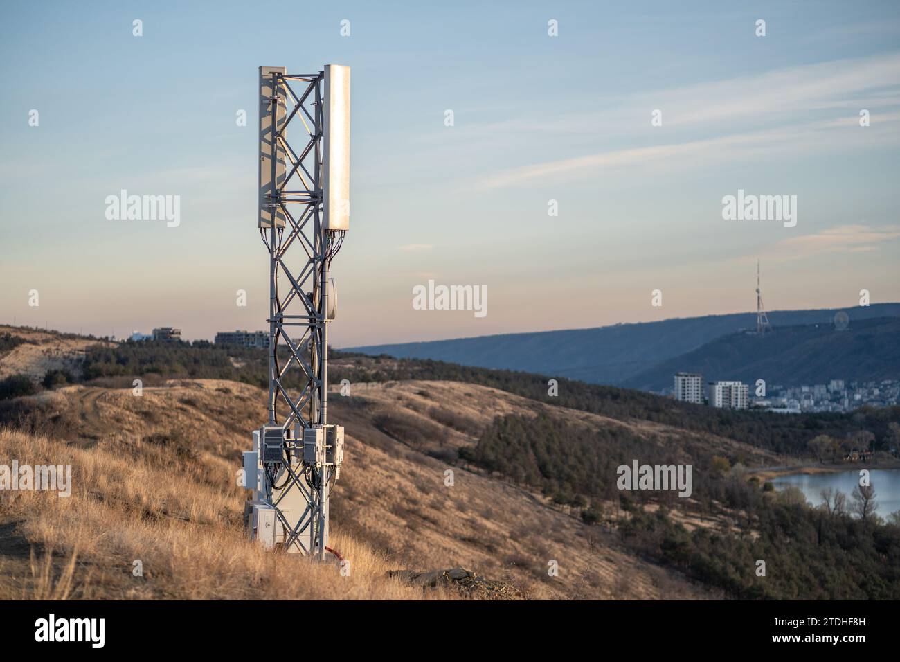 Cellular tower covering wide area, transmitting 5G signals for mobile phone, internet connection  Stock Photo