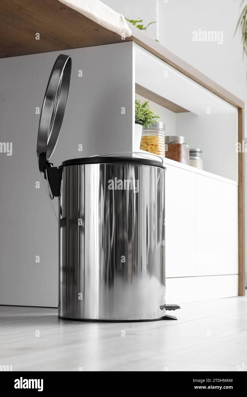 Opened trash bin in interior of light kitchen Stock Photo