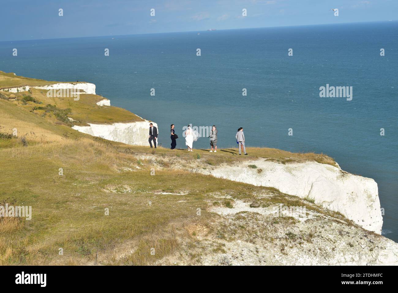 Newly wed couple holding a photoshoot on the top of the scenic White Cliffs of Dover Stock Photo