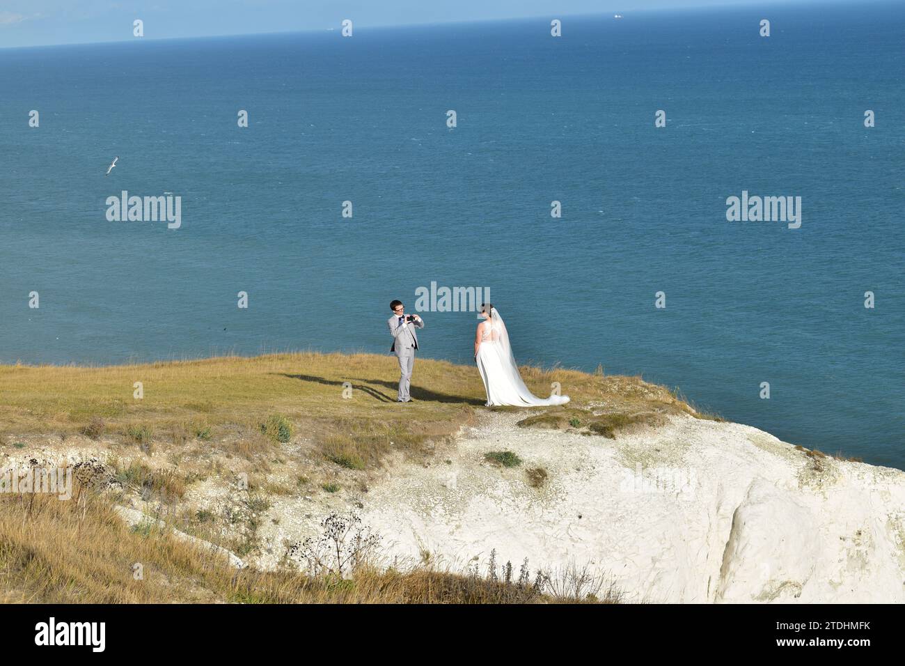 Newly wed couple holding a photoshoot on the top of the scenic White Cliffs of Dover Stock Photo