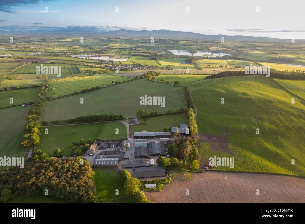 Farmstead in the Eden valley near Carlisle, looking towards the mountains of the Lake District, Cumbria, UK. Stock Photo
