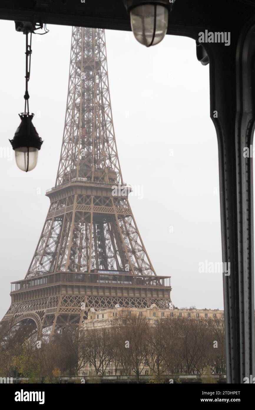 The Eiffel Tower under the Bir Hakeim bridge in the rain in Paris - France Stock Photo