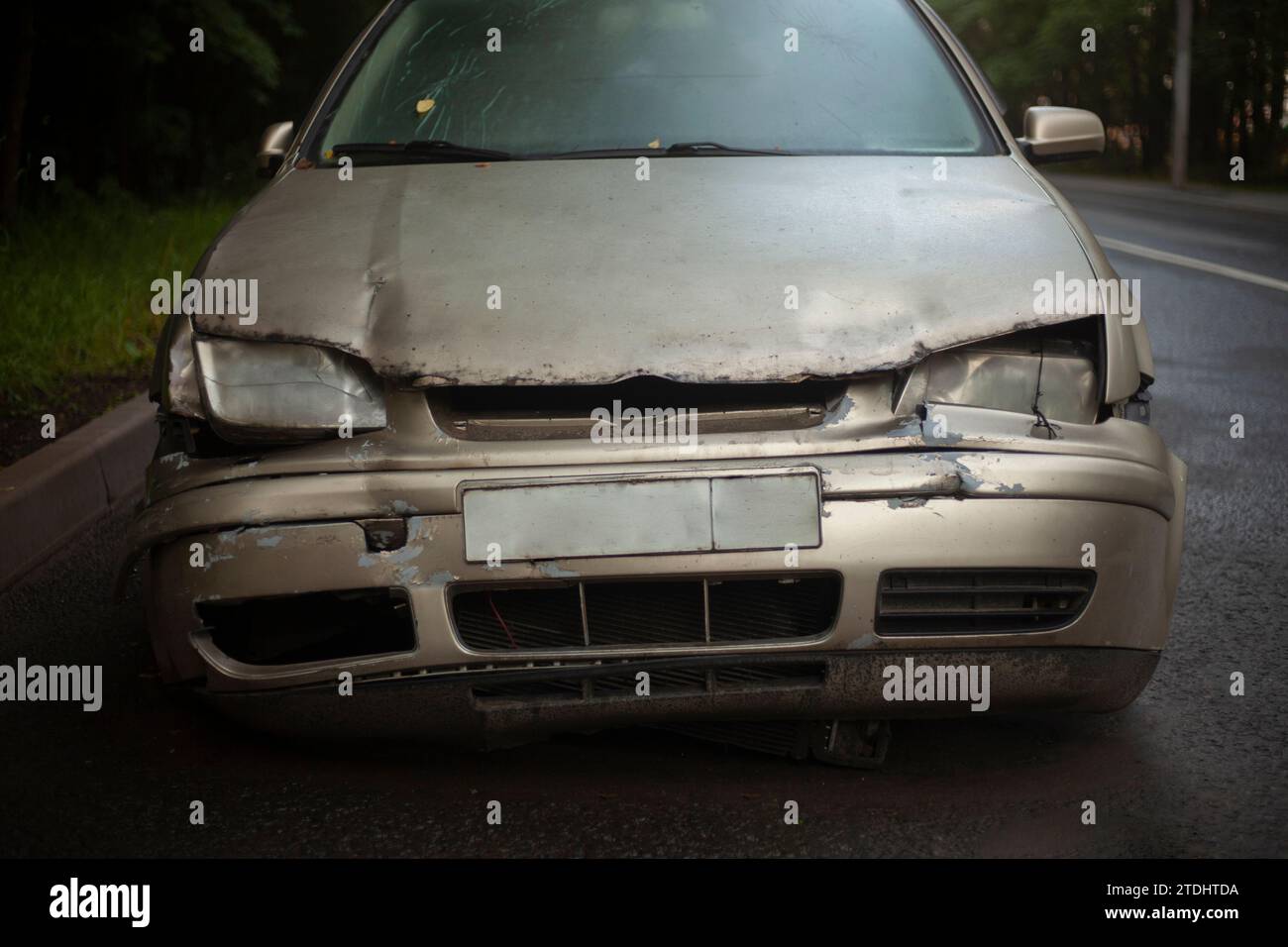 Wrecked car on the street. Old car. Dented hood. Transport after the