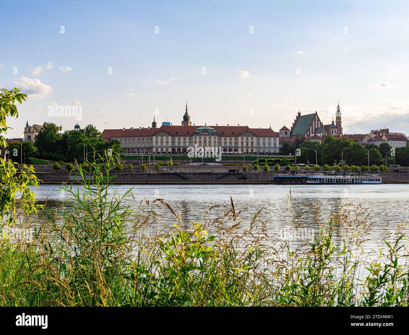 Warsaw, Masovia, Poland - July 10 2023: View of Warsaw Royal Castle and the Old Town Seen from the Opposite Bank of the Vistula River. Early Evening. Stock Photo