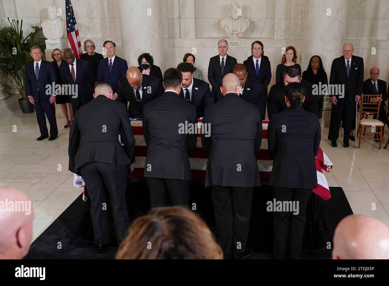 United States Supreme Court Police officers place the flag draped United States Supreme Court Police officers place the flag draped
