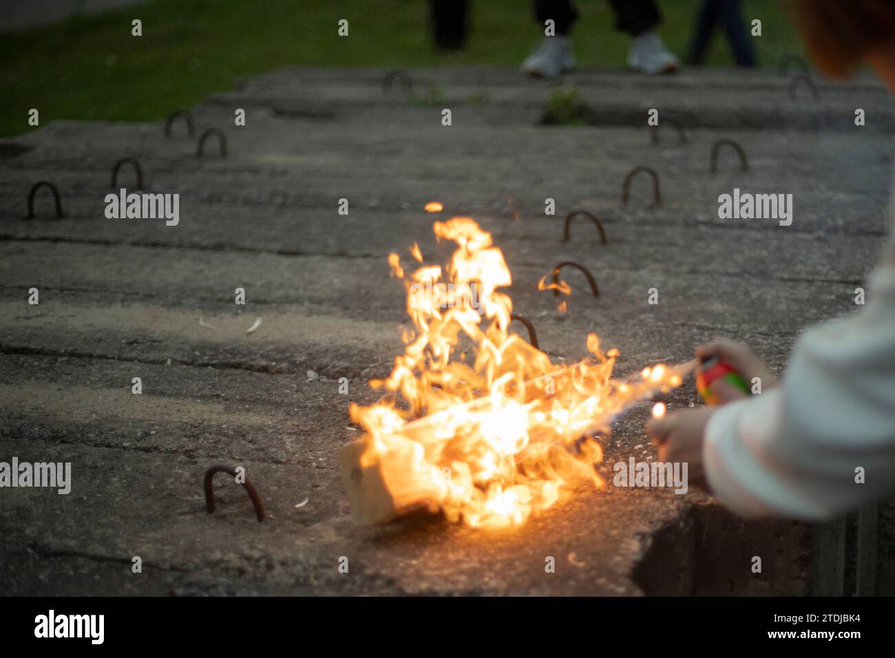 Spraying an aerosol on a flame. Waiting for gas from a spray can. Playing with fire. Dangerous flames. Stock Photo