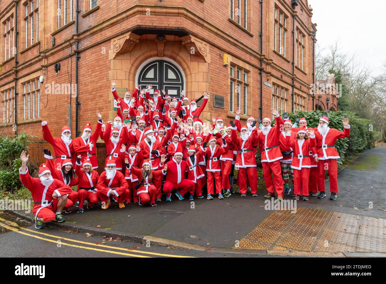 The 2023 Santa Dash ran through the village of Lymm, Cheshire, at the Dickensian Day Festival. A lot posed on steps for a photo Stock Photo