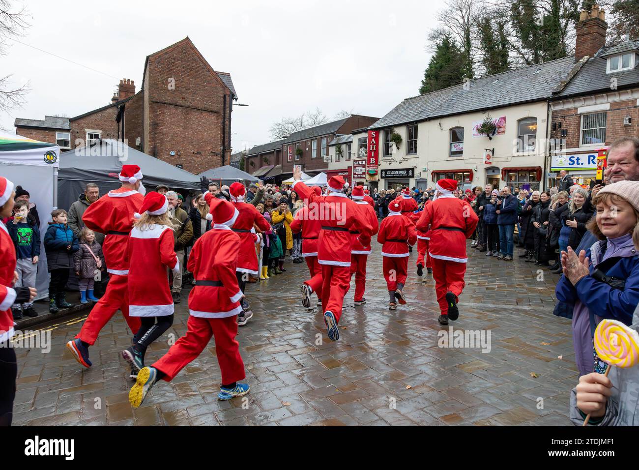 The 2023 Santa Dash ran through the village of Lymm, Cheshire, at the Dickensian Day Festival Stock Photo