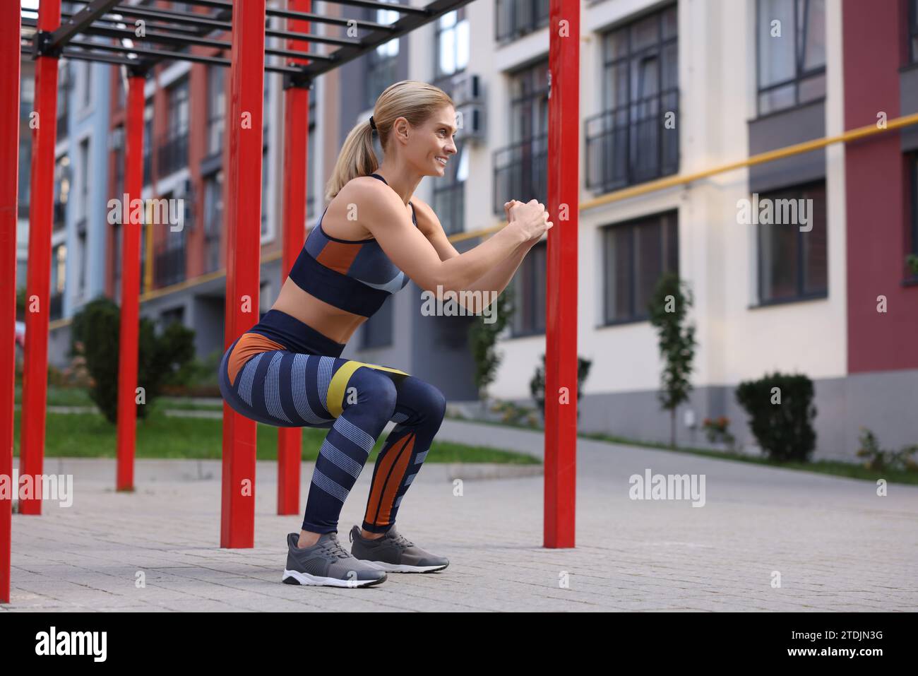 Adult woman squats outdoor resistance hi-res stock photography and ...