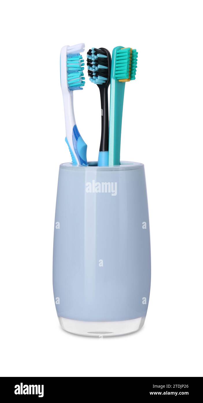 Different toothbrushes in holder isolated on white Stock Photo - Alamy