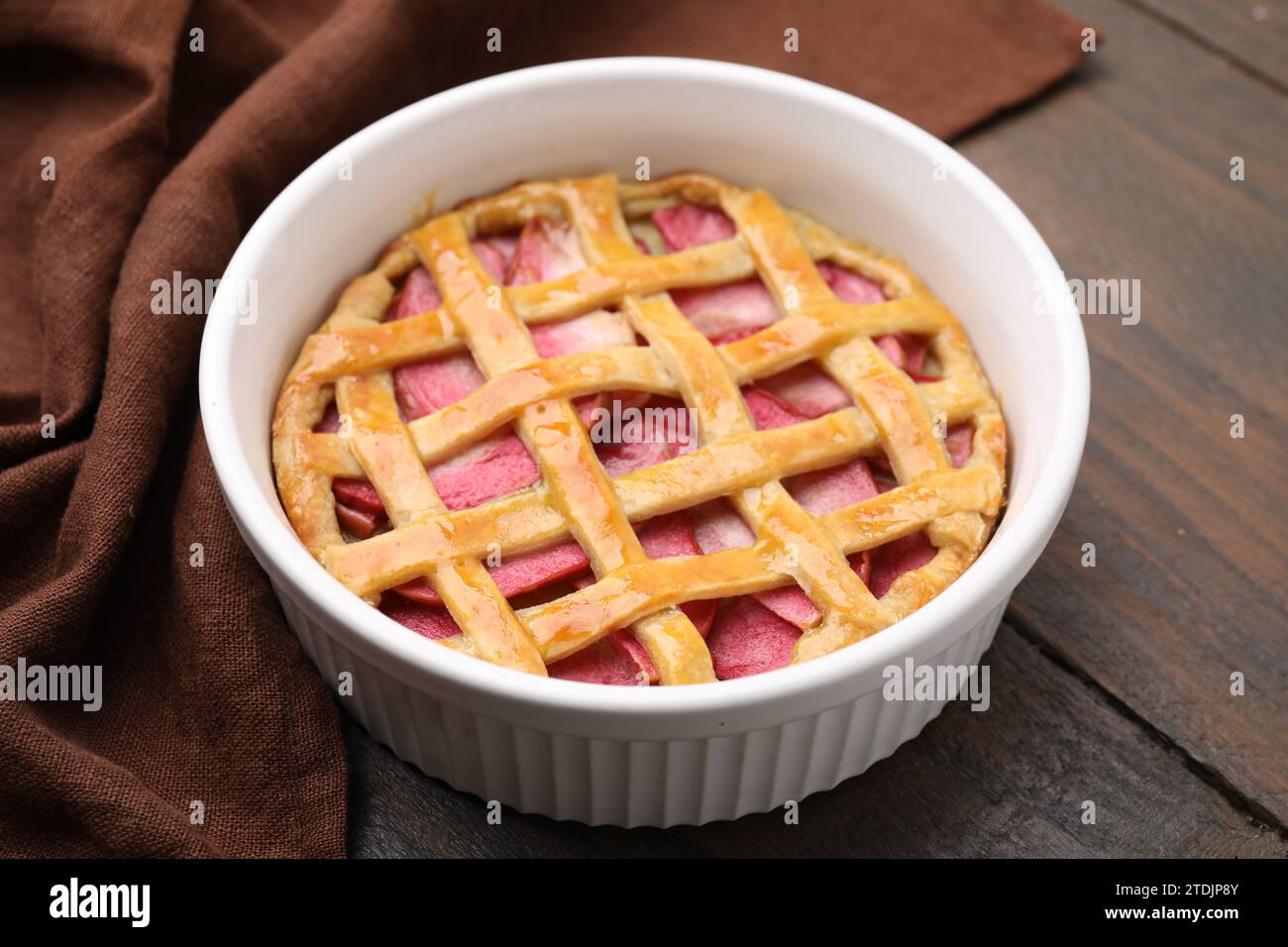 Baking dish with tasty apple pie on wooden table, closeup Stock Photo