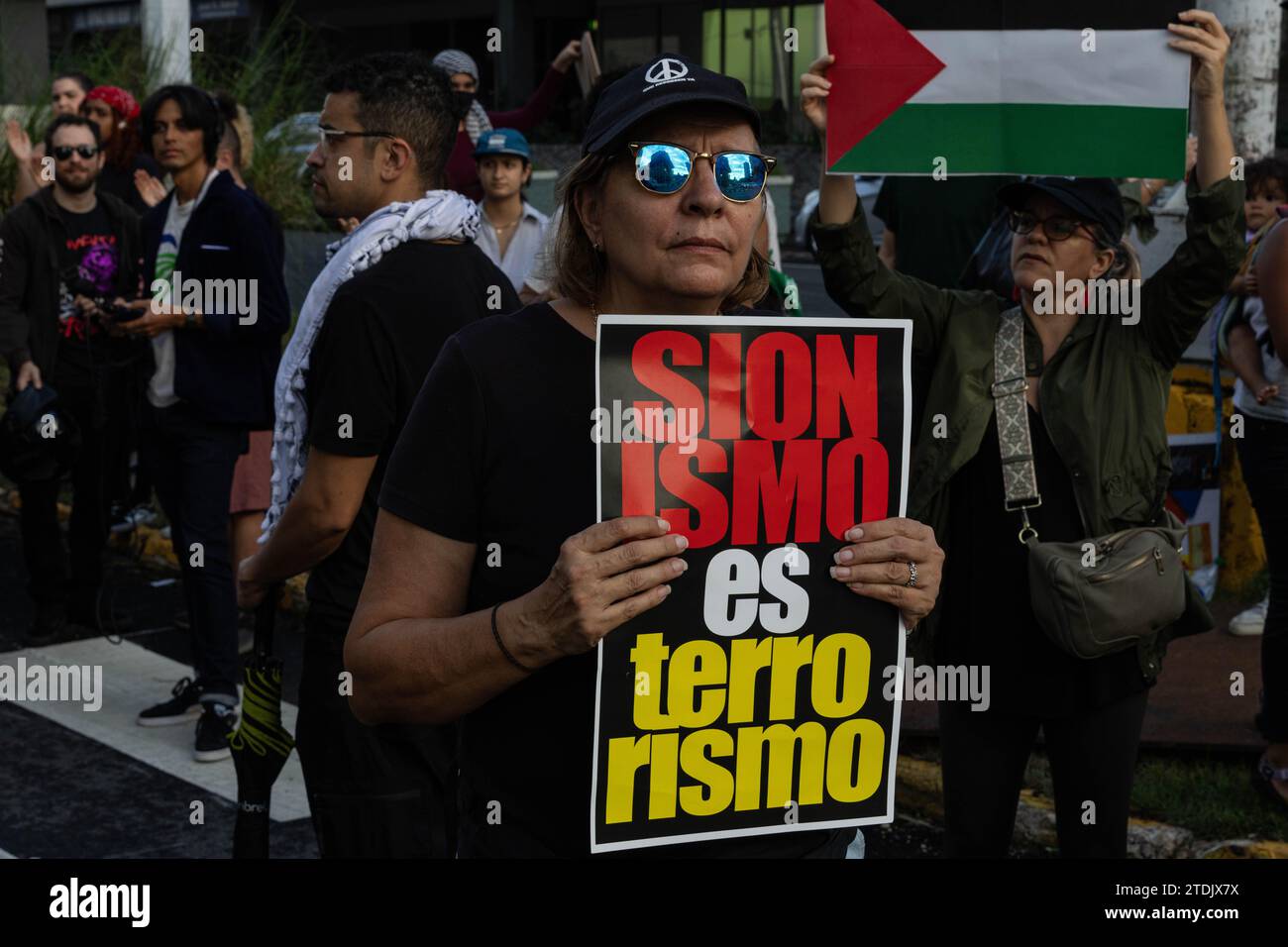 San Juan, USA. 18th Dec, 2023. A protesters holds a “Zionism is terrorism” sign in “La Milla de Oro” in San Juan, Puerto Rico on Dec. 18, 2023. Many Puerto Ricans identify themselves with the Palestinian struggle because of the continuous colonization of Puerto Rico by the United States. (Photo by Carlos Berríos Polanco/Sipa USA) Credit: Sipa USA/Alamy Live News Stock Photo