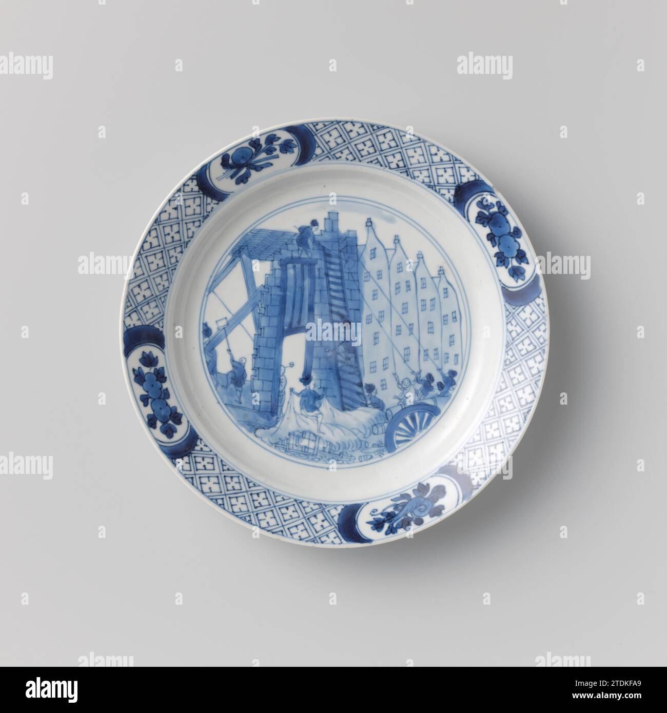 Plate with the Costerman revolt, the plundering of the house of Jacob van Zuylen, anonymous, c. 1690 - c. 1700 Plate of porcelain, painted in underlaze blue. On the flat a representation of the Costerman riot with the looting and demolition of the Huis van de Main Schout Jacob van Zuylen van Nyevelt, the left in line; in the foreground cannons; Behind it a group of men who try to pull the facade with the help of ropes; Furthermore, a man on Ladder, a man who ways woodwork from the house, and a man with broom. The edge with servetwork with four cartouches with flower branches saved. The back wi Stock Photo