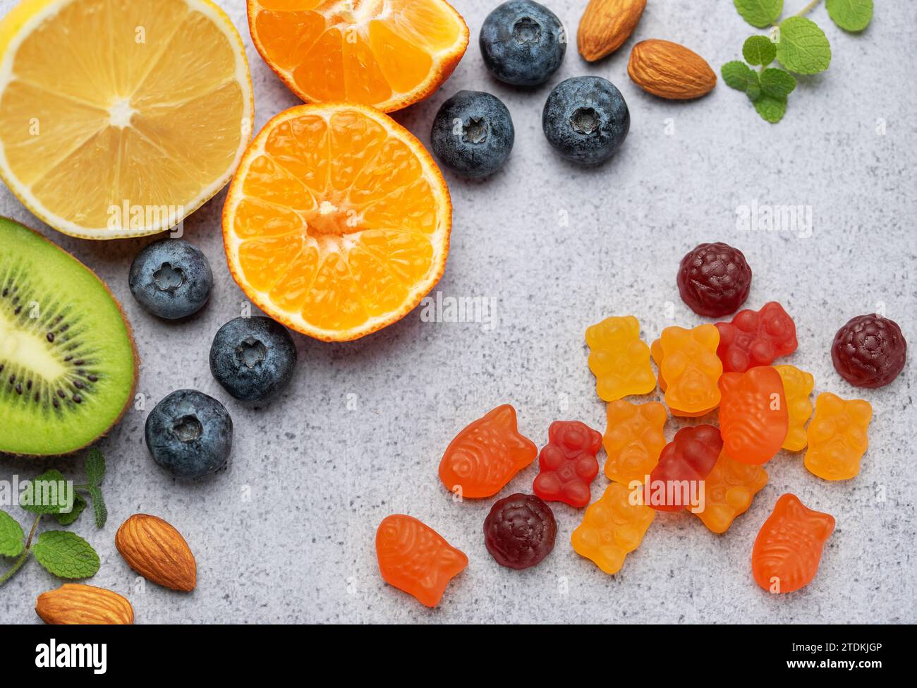 Chewable gummy bears vitamins and supplements and fresh fruits Stock