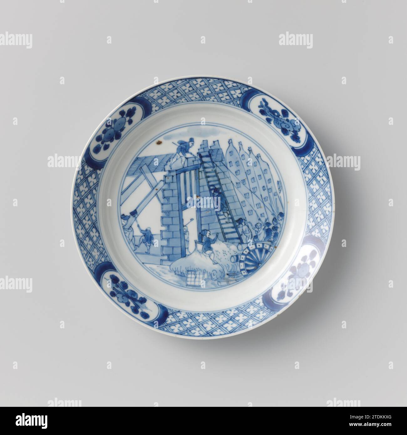 Plate with the Costerman revolt, the plundering of the house of Jacob van Zuylen, anonymous, c. 1690 - c. 1700 Plate of porcelain, painted in underlaze blue. On the flat a performance of the Costerman riot with the looting and demolition of the Huis van de Main Schout Jacob van Zuylen van Nyevelt, the left in line; in the foreground cannons; Behind it a group of men who try to pull the facade with the help of ropes; Furthermore, a man on Ladder, a man who ways woodwork from the house, and a man with broom. The edge with servetwork with four cartouches with mushrooms (lingzhi) or fruit branches Stock Photo