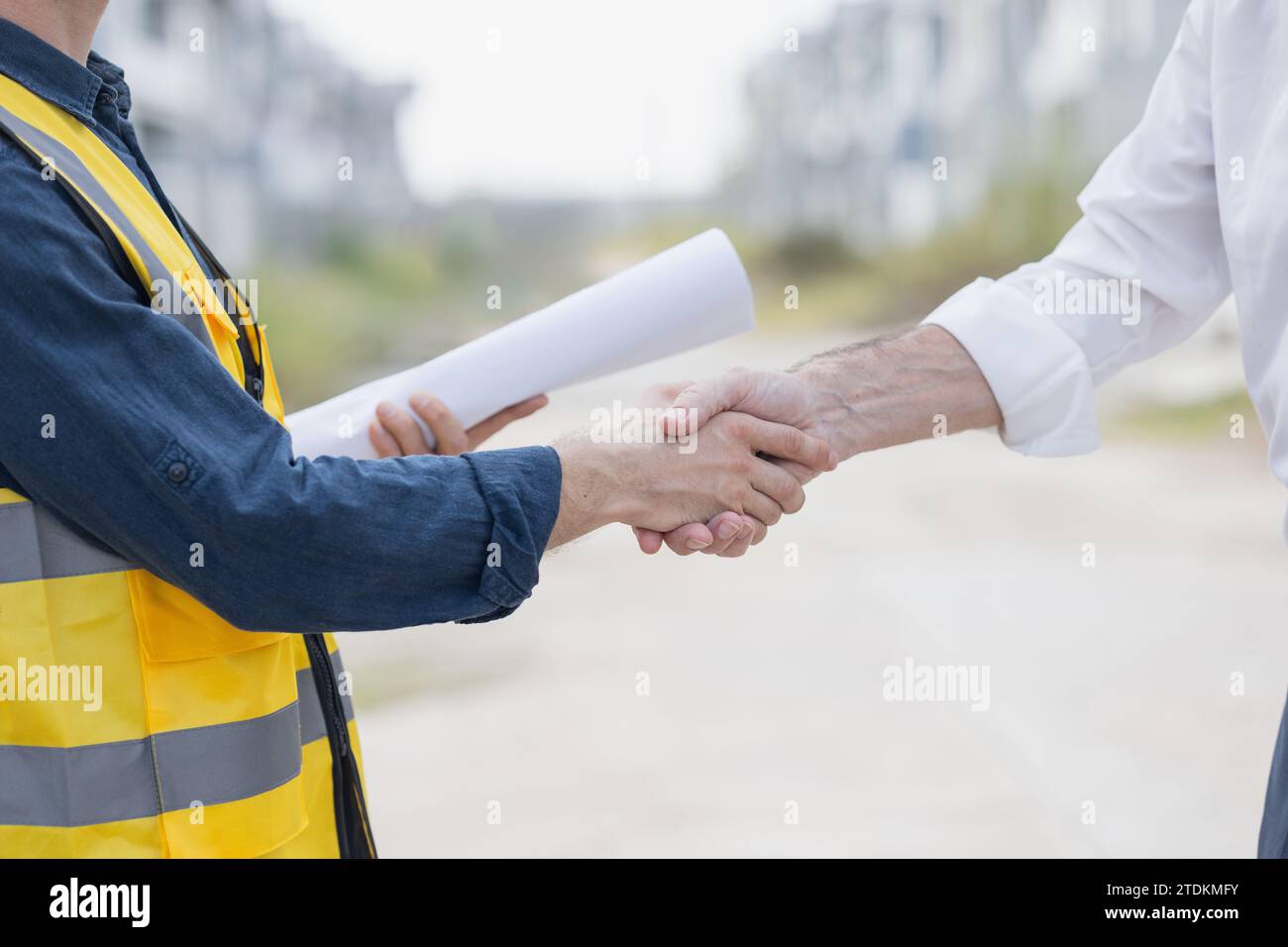 Construction partnership. Engineer handshake with business team contact. Deal building project. Thank you finished done agreement people. Shaking hand Stock Photo