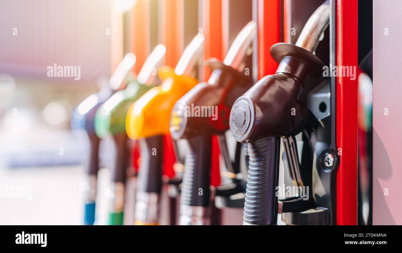 Diesel petrol fuel pistols nozzle refill at gas station. Fuel price crisis impact fuel cost in transport business and Travel energy consumption rise i Stock Photo