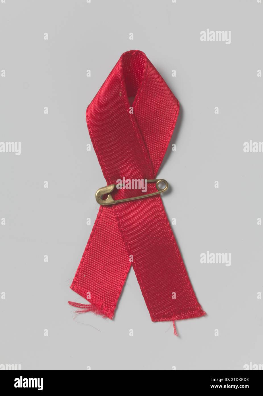 Aidslintje with Safety Pin, 1989 Red Ribbon with safety pin. A red loop ...
