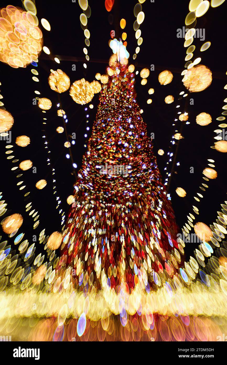 Christmas and Happy new year blurred bokeh. Authentic shot of colorful light on outdoor christmas tree with bokeh. Beautiful christmas bokeh backgroun Stock Photo