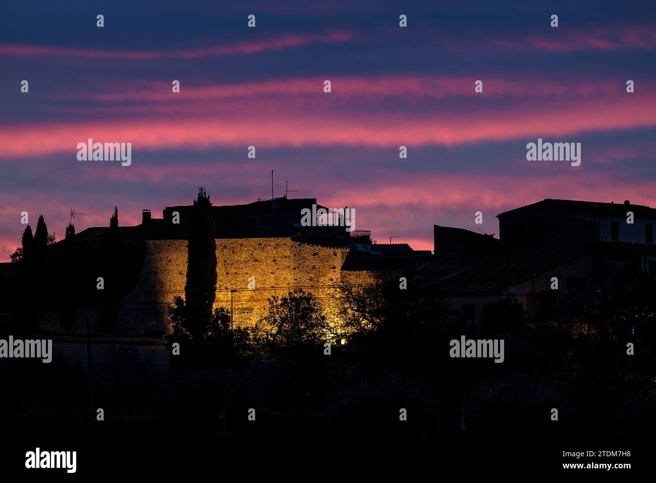 Marzà Castle illuminated at dawn with reddish sky (Alt Empordà, Gerona, Catalonia, Spain) ESP: Castillo de Marzà iluminado en un amanecer (Gerona) Stock Photo