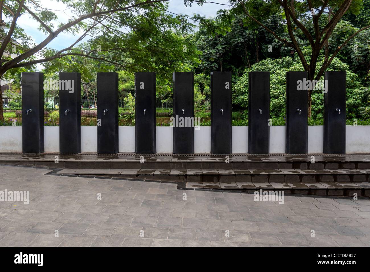 A row of water tap ablution places for Muslims before entrance or praying in the mosque Stock Photo