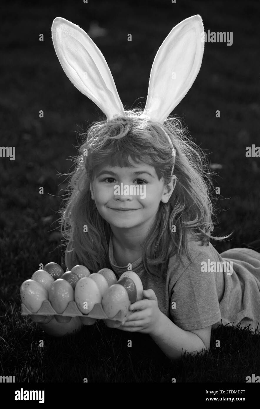 Kids boy in rabbit costume with bunny ears hunting easter eggs. Child