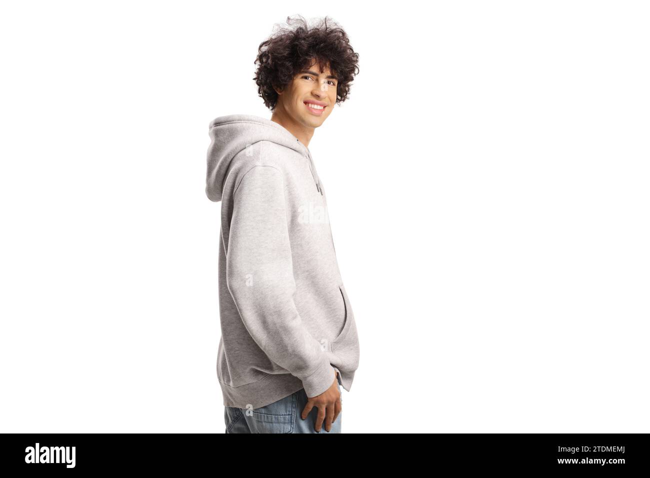 Guy with curly hair in a gray hoodie smiling isolated on white background Stock Photo