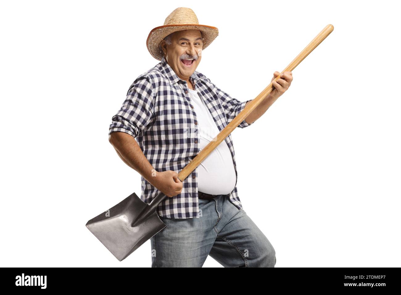 Mature farmer dancing with a shovel isolated on white background Stock ...