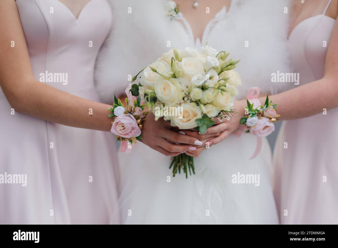 A beautiful wedding bouquet in the hands of the bride. Bouquet with white roses in the hands of the bride Stock Photo