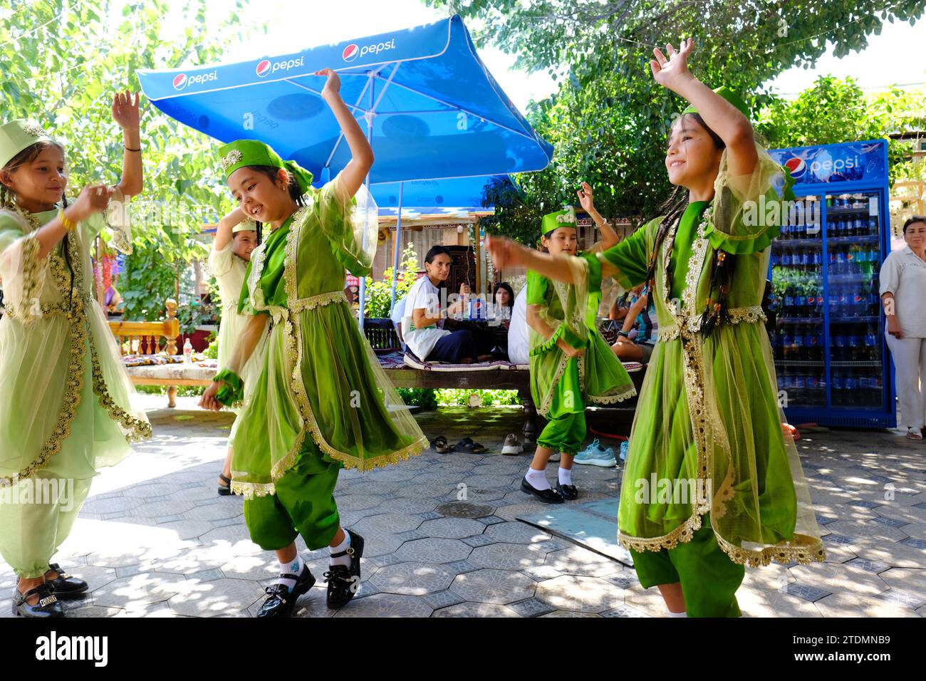 Samarkand Uzbekistan young local Uzbek girls dance at an open air cafe near the Registan in August 2022 Stock Photo