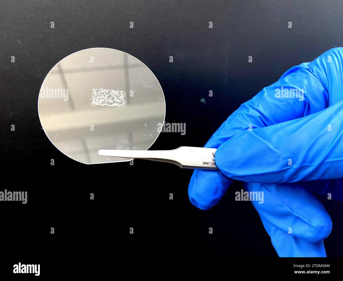 (231219) -- BEIJING, Dec. 19, 2023 (Xinhua) -- This photo taken on Dec. 15, 2023 shows a Twist Boron Nitride (TBN) crystal placed on a piece of fused silica in Peking University, Beijing, capital of China. A team of Chinese researchers used a novel theory to invent a new type of ultrathin optical crystal with high energy efficiency, laying the foundation for next-generation laser technology. The research findings were recently published in the journal Physical Review Letters. TO GO WITH 'China Focus: Chinese scientists invent ultrathin optical crystal for next-generation laser tech' (Xinh Stock Photo