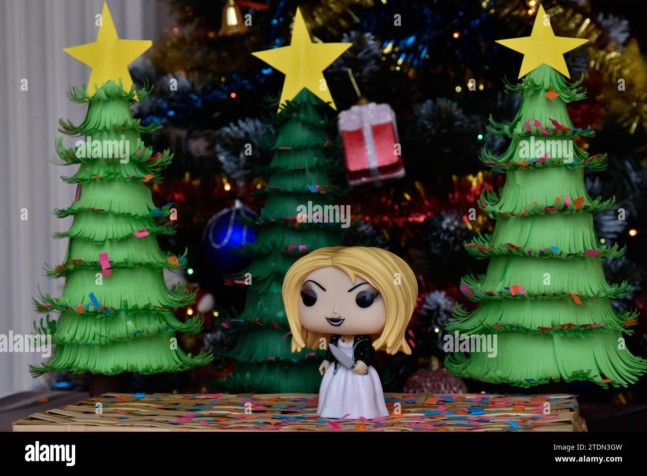 Funko Pop action figure of Tiffany bride of Chucky from popular horror franchise Child's Play. Killer doll, handmade paper Christmas trees, festive. Stock Photo