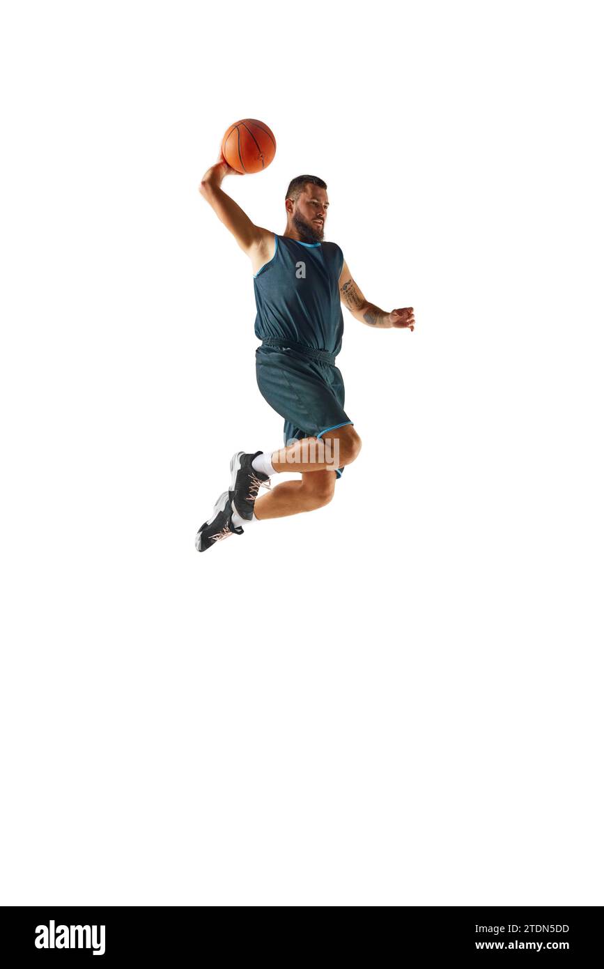 Perfect slam dunk. Basketball player in uniform demonstrates strength