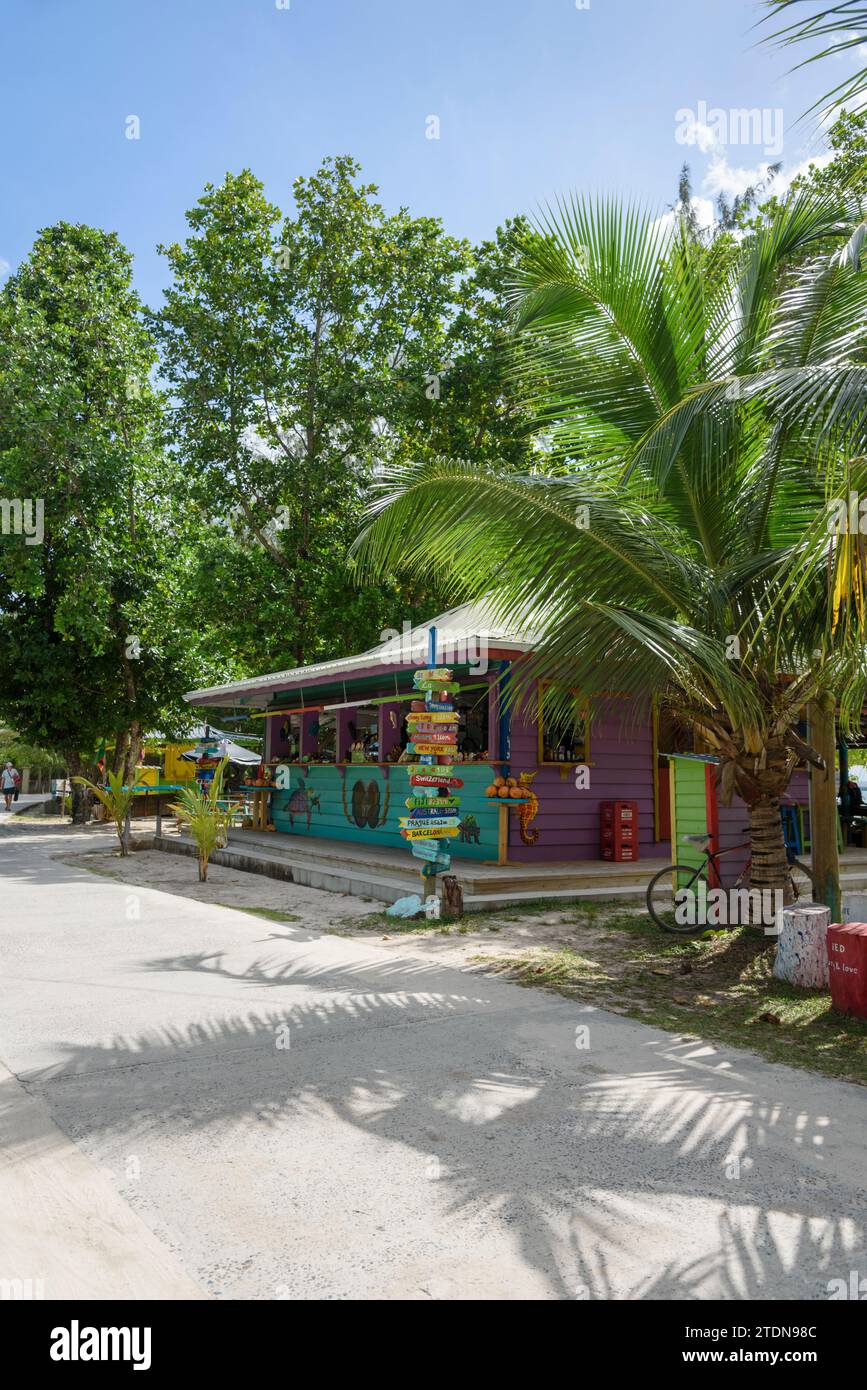 Colourful painted wooden souvenir shop for tourists at Anse Severe beach, La Digue Island