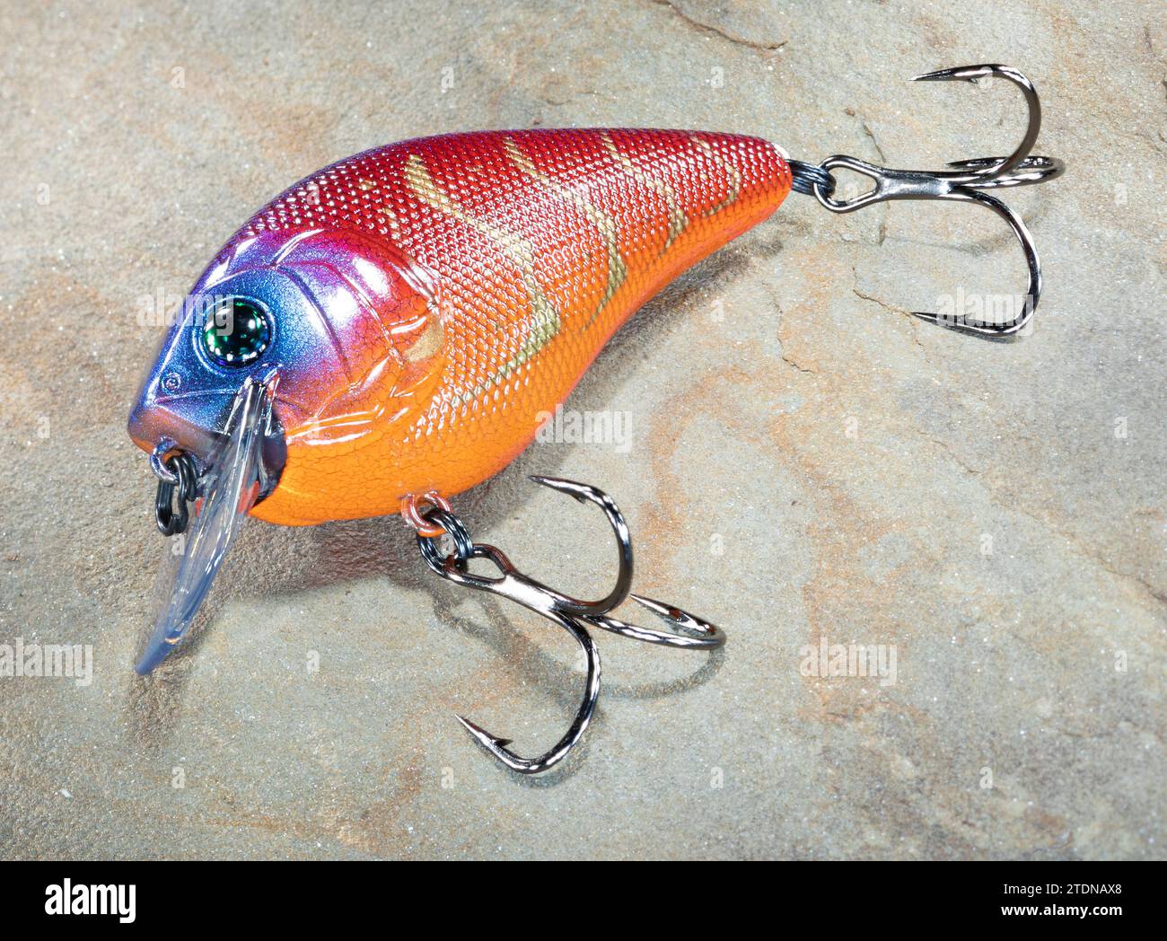 Treble fish hook on blue background Stock Photo - Alamy