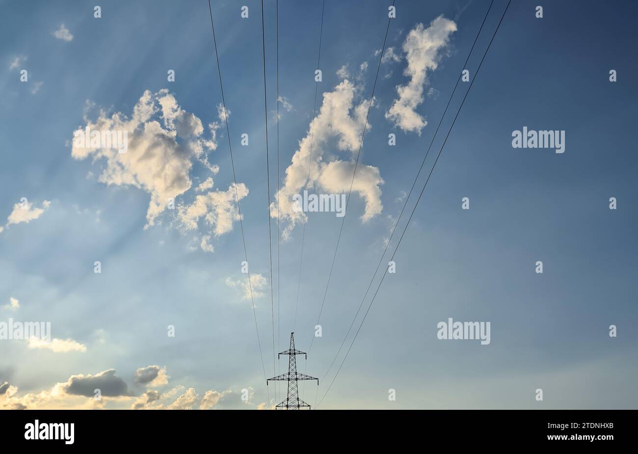 Electric wires from power lines on background of blue sky with clouds ...