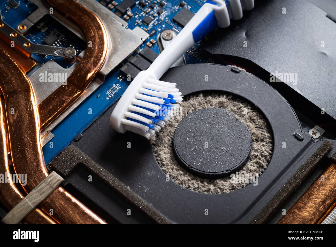 Dirty laptop computer fan full of dust and needs cleaning using a toothbrush Stock Photo Alamy