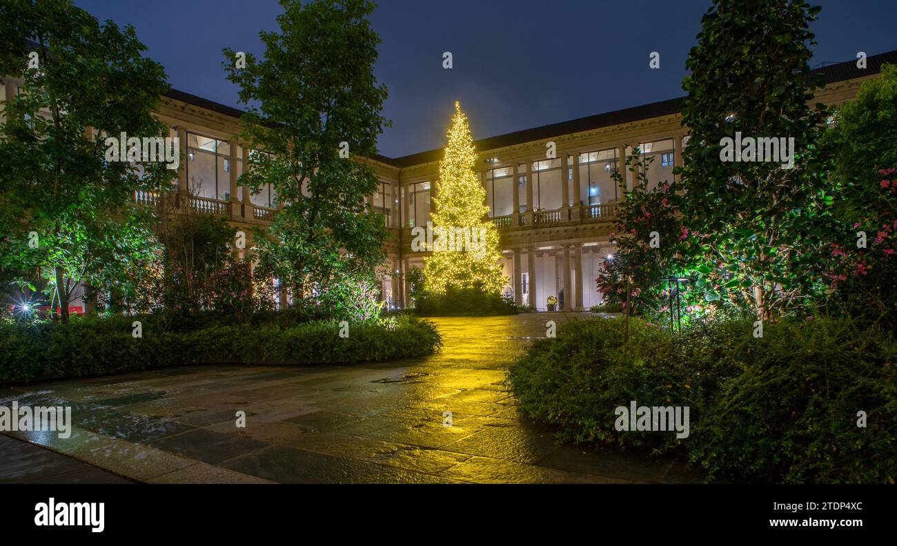 Cloister with garden and tree illuminated with LED bulbs for energy saving Stock Photo