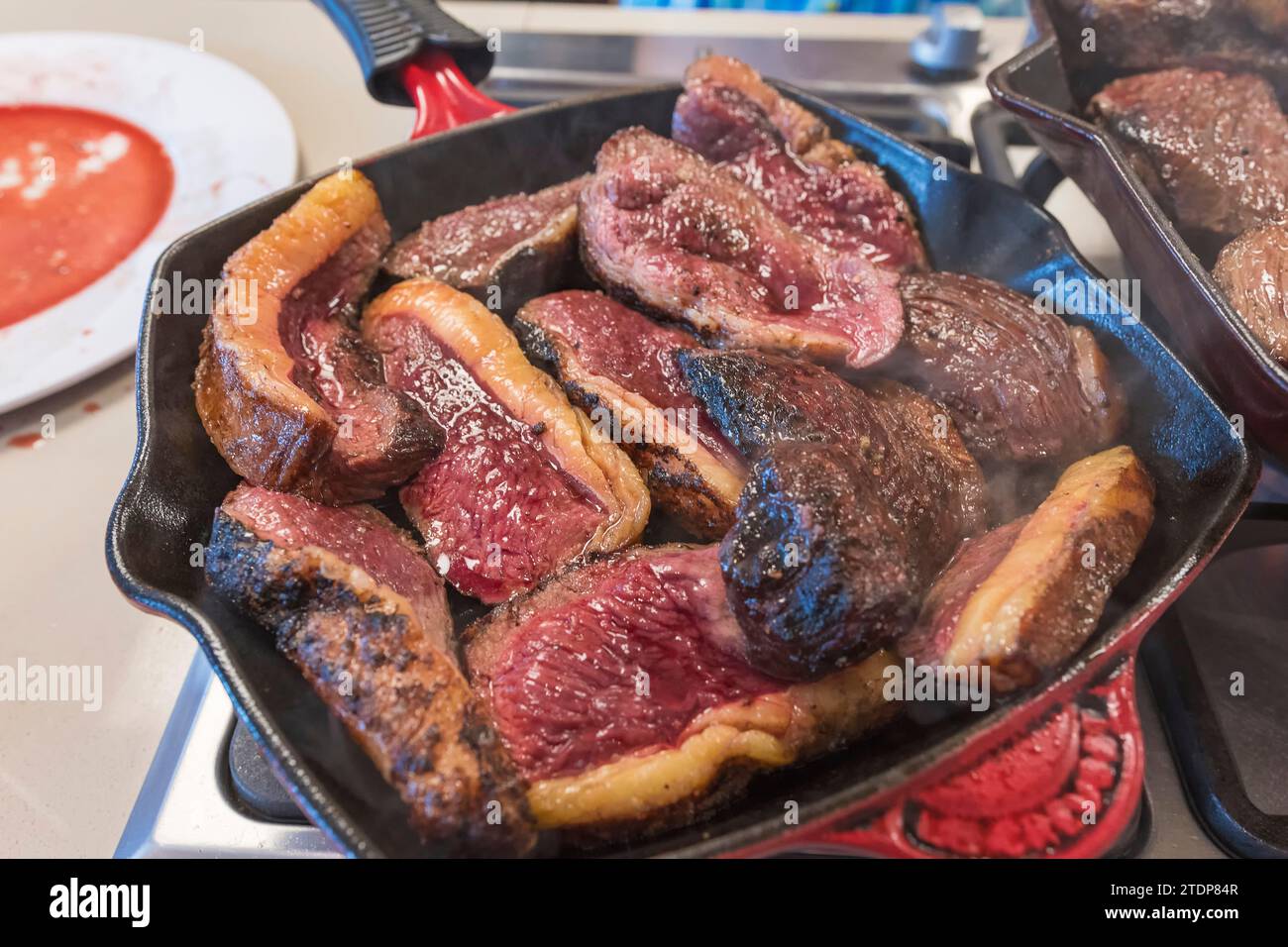 Grilled sirloin or rump fillets seen up close in the frying pan. Stock Photo