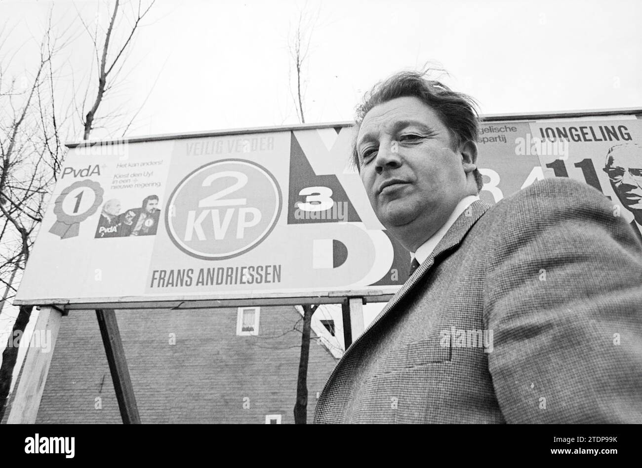 Politician in front of election billboard, Whizgle News from the Past, Tailored for the Future. Explore historical narratives, Dutch The Netherlands agency image with a modern perspective, bridging the gap between yesterday's events and tomorrow's insights. A timeless journey shaping the stories that shape our future Stock Photo