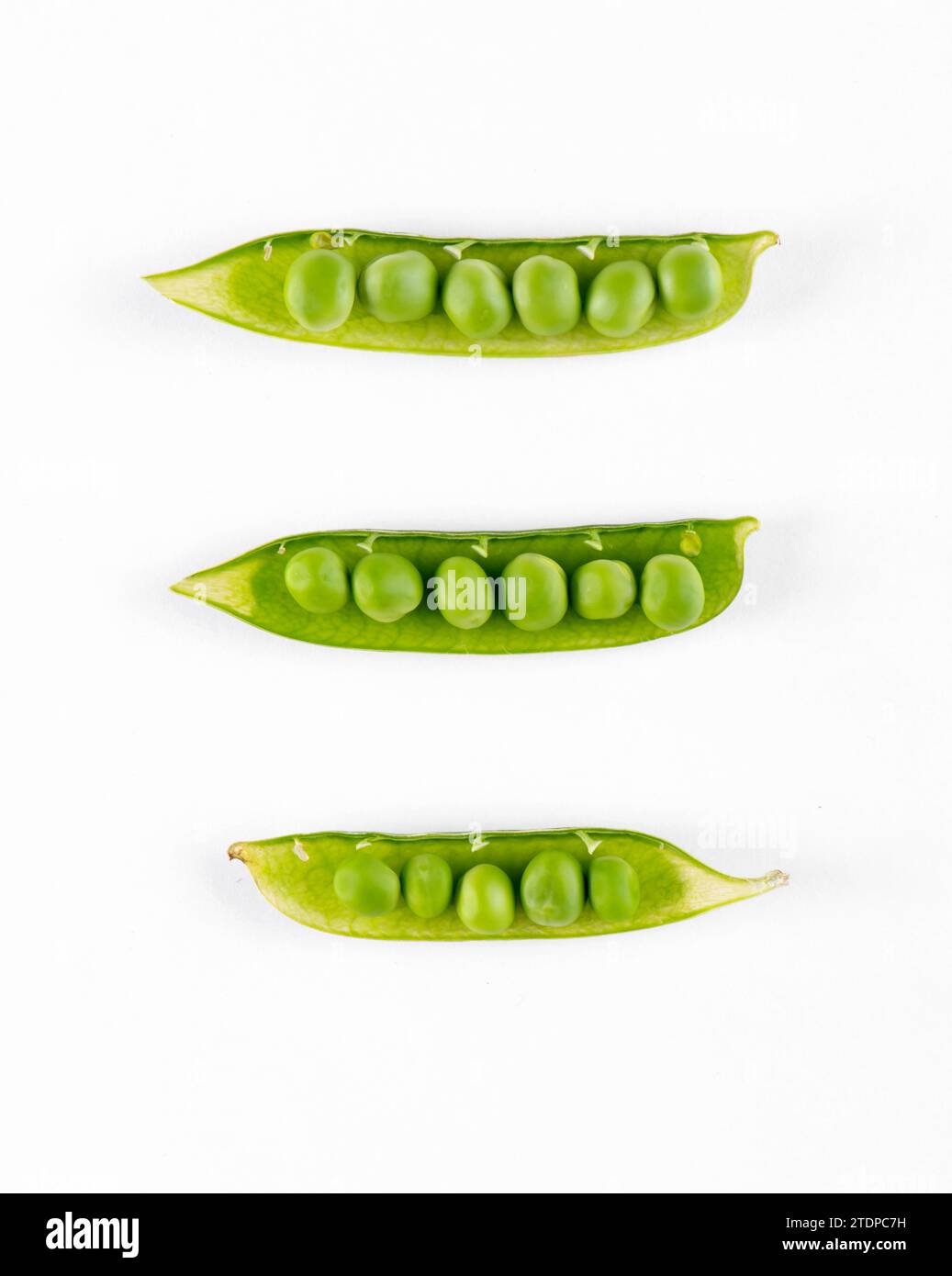 Pods with fresh green peas on white background Stock Photo