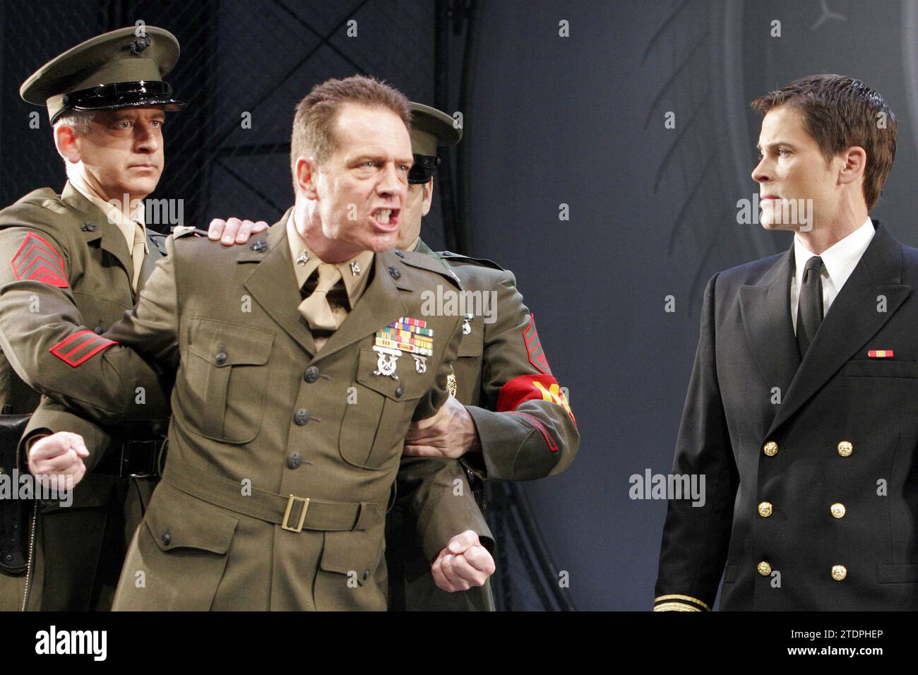 l-r: Patrick Poletti (M.P.), Jack Ellis (Col. Nathan R. Jessup), Rob Lowe (Lt. Daniel A. Kaffee) in A FEW GOOD MEN by Aaron Sorkin at the Theatre Royal Haymarket, London SW1 06/09/2005  set design: Michael Pavelka  costumes: Elizabeth Hope Clancy  lighting: Mark Henderson  director: David Esbjornson Stock Photo