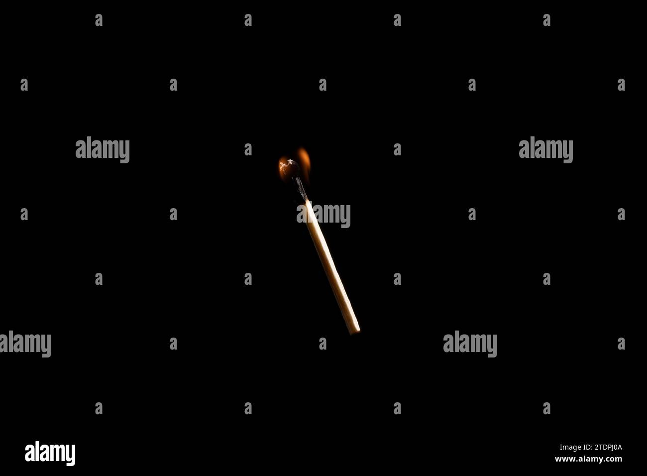 Lit and falling match on a black background. Stock Photo