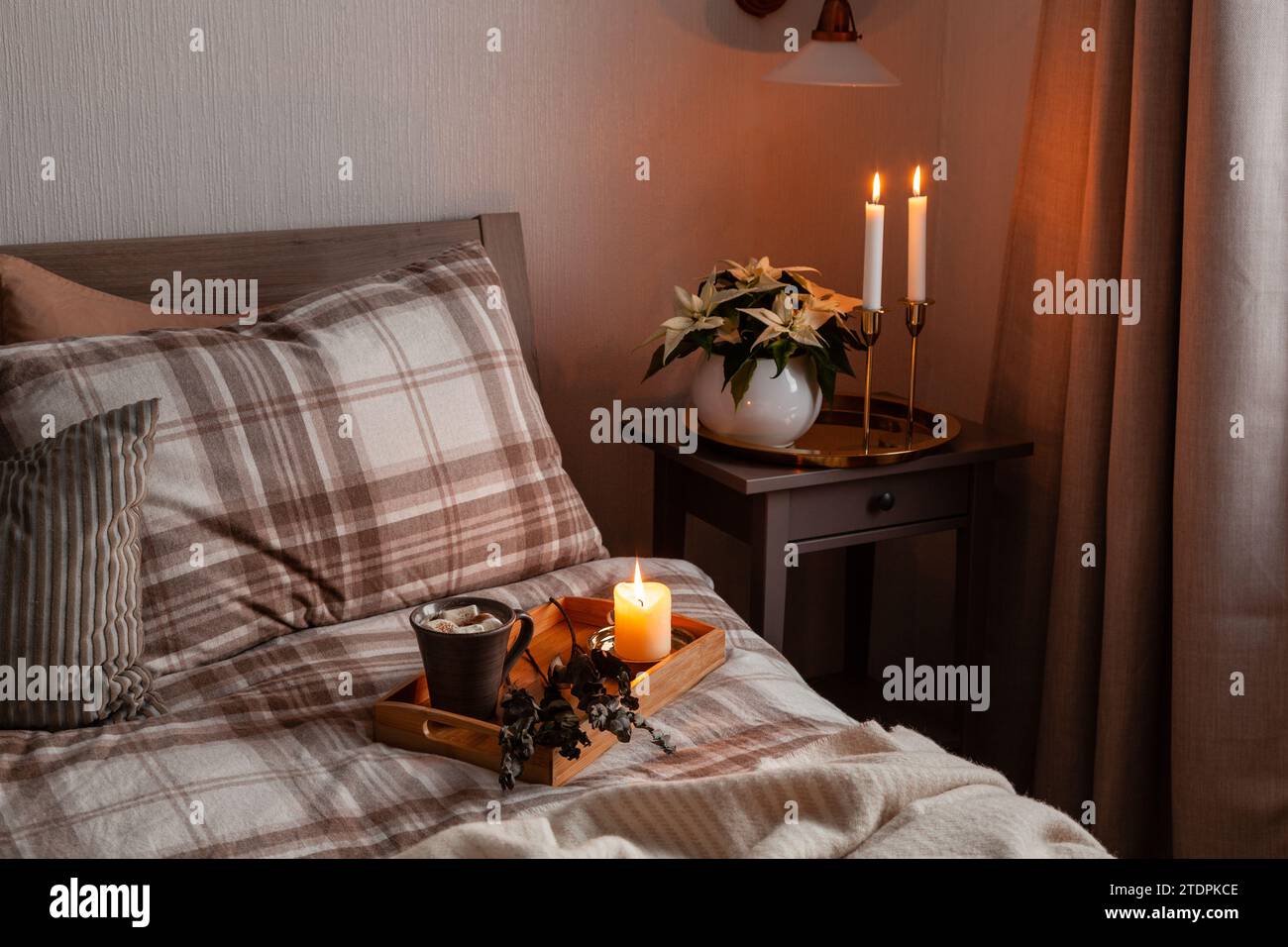 cozy scandinavian bedroom interior in natural tones, blanket candles houseplants Stock Photo