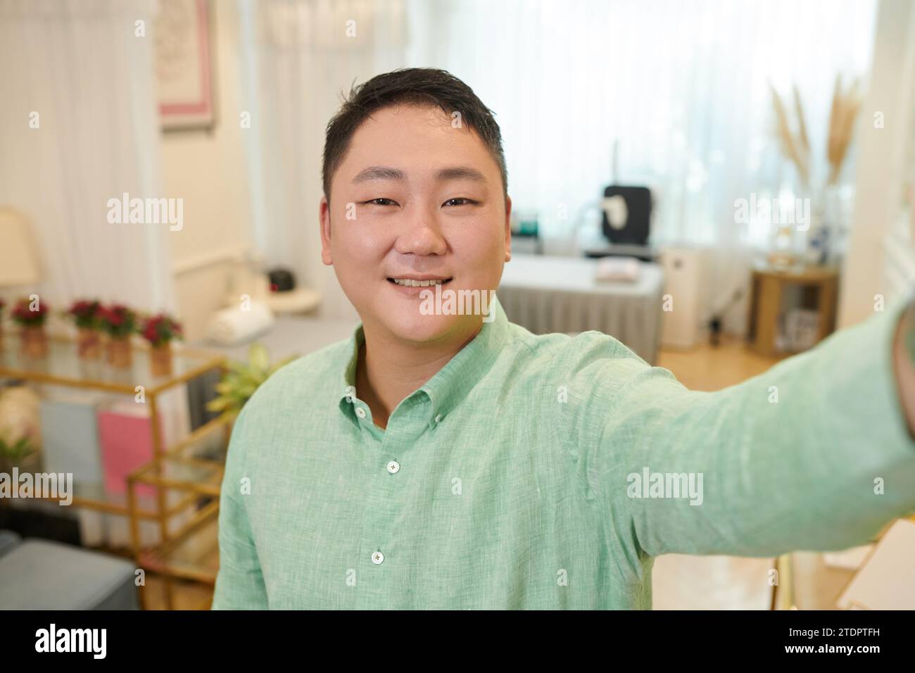 Smiling beauty salon owner taking selfie for social media Stock Photo