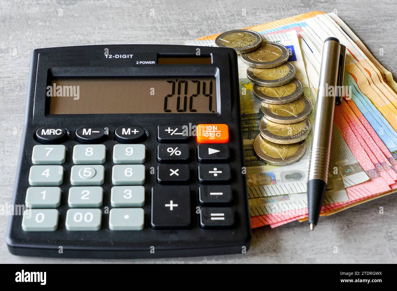 Calculator with number 2025 on display, pen, euro banknotes and euro